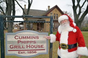 Santa in front of cummins house sign